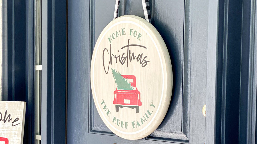 plaque hanging on door that says home for christmas
