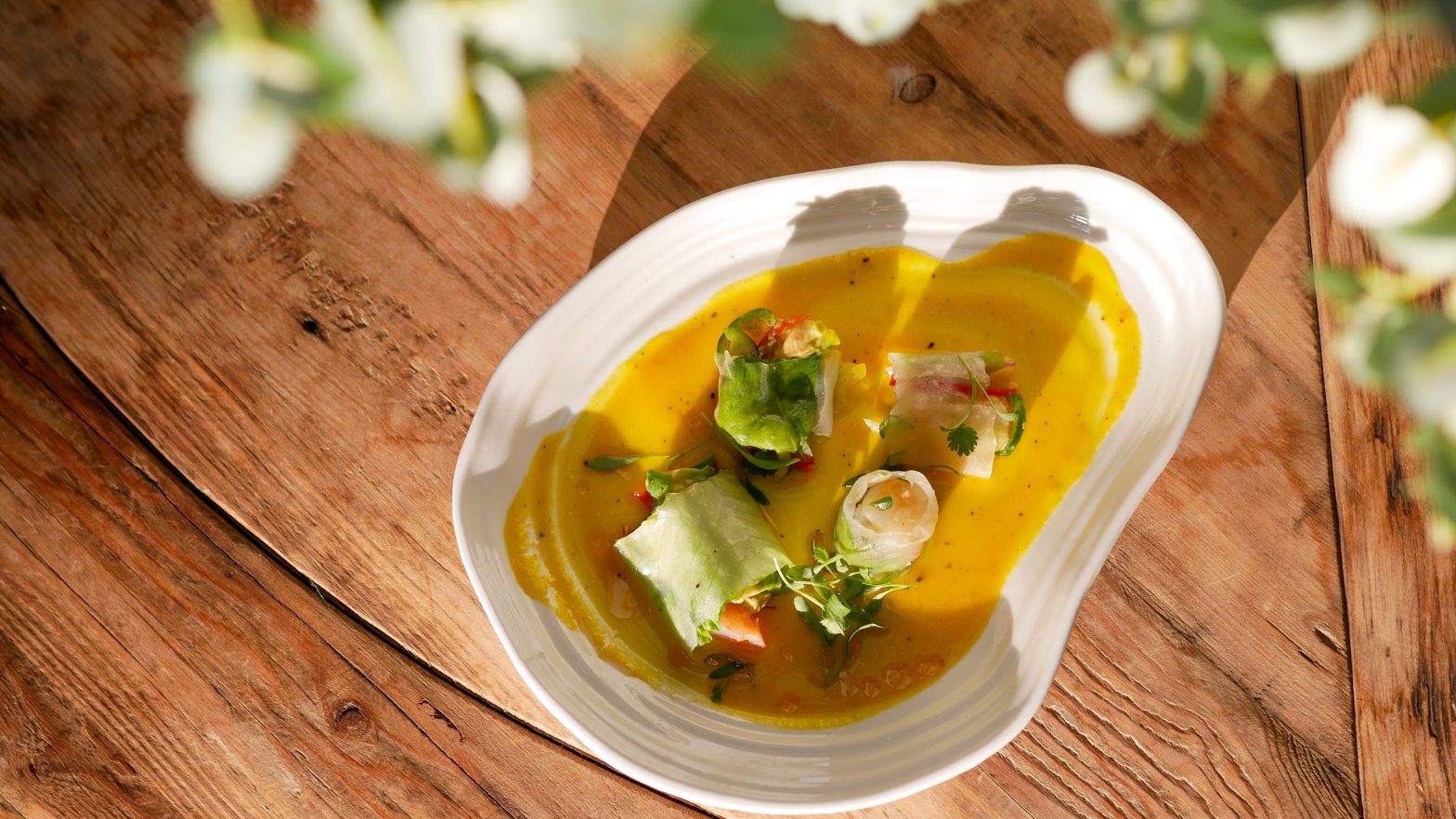 food on a decorative white plate on a wooden table